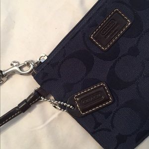 Small navy Coach wristlet with brown leather